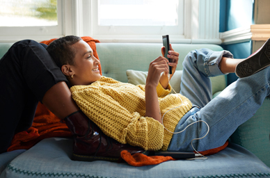 Woman lounging with mobile phone